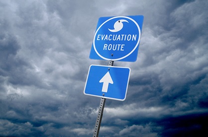 hurricane clouds and evacuation sign