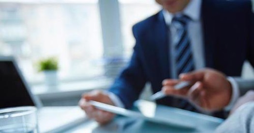 businessman in office with papers